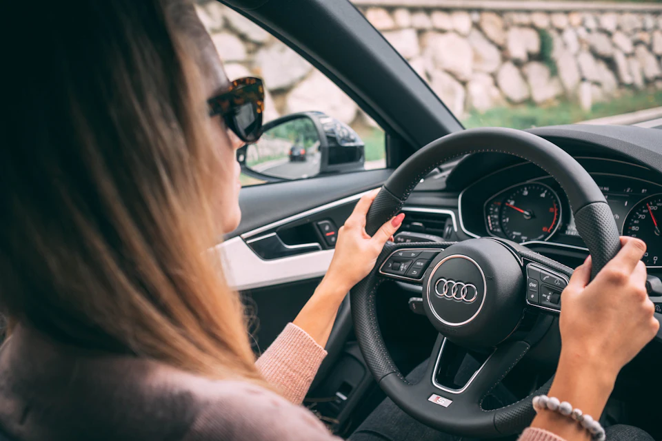 Driver holding a car steering wheel